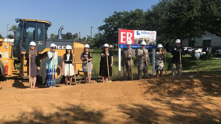 HCA employees participate in the ceremonial first dirt toss during the groundbreaking for Millenia ER